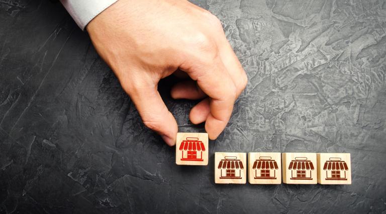 business wooden figurines with one being taken away