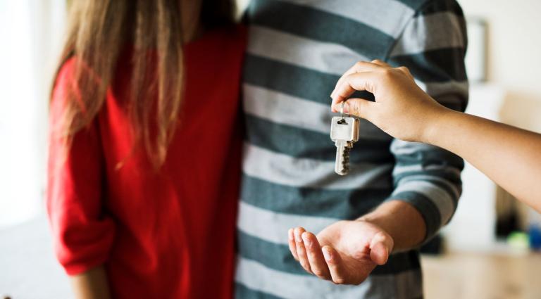 couple receiving keys from the landlord