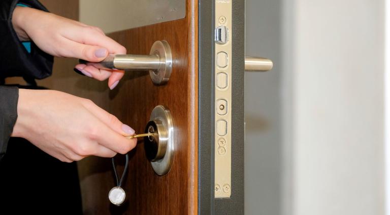 hands open a door key lock