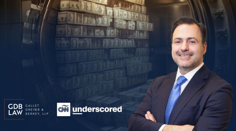 Asher Rubinstein in front of a bank vault talking about Asset Protection with CNN Underscored