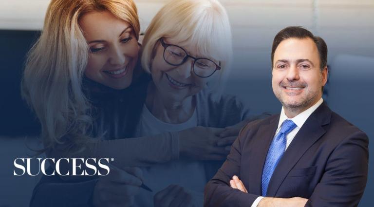 Professional portrait of attorney Asher Rubinstein smiling in a suit and blue tie, positioned in the foreground. In the background, a younger woman affectionately hugs an older woman with white hair and glasses, both smiling warmly. The SUCCESS magazine logo is displayed in the bottom-left corner.