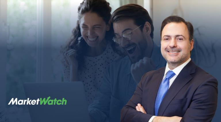 Attorney Asher Rubinstein stands confidently in the foreground, smiling in a suit and blue tie. In the background, a joyful couple raises their fists in celebration while looking at a laptop screen. The MarketWatch logo appears in the bottom-left corner.